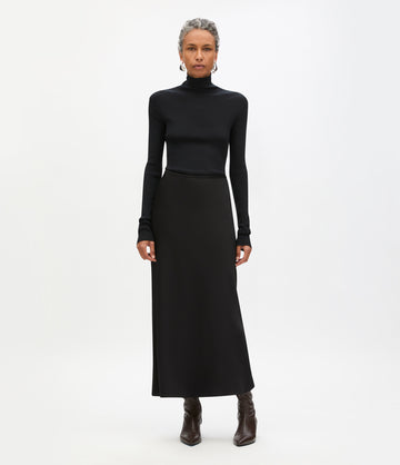 Dark brown ankle boots with all-black evening outfit